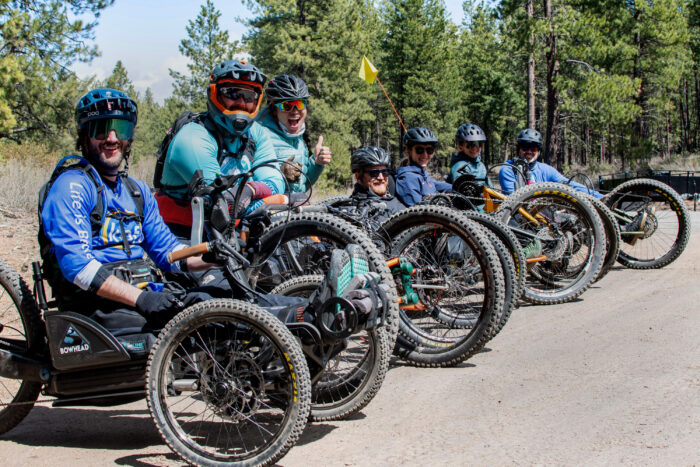 several adaptive mountain bikers getting ready to ride