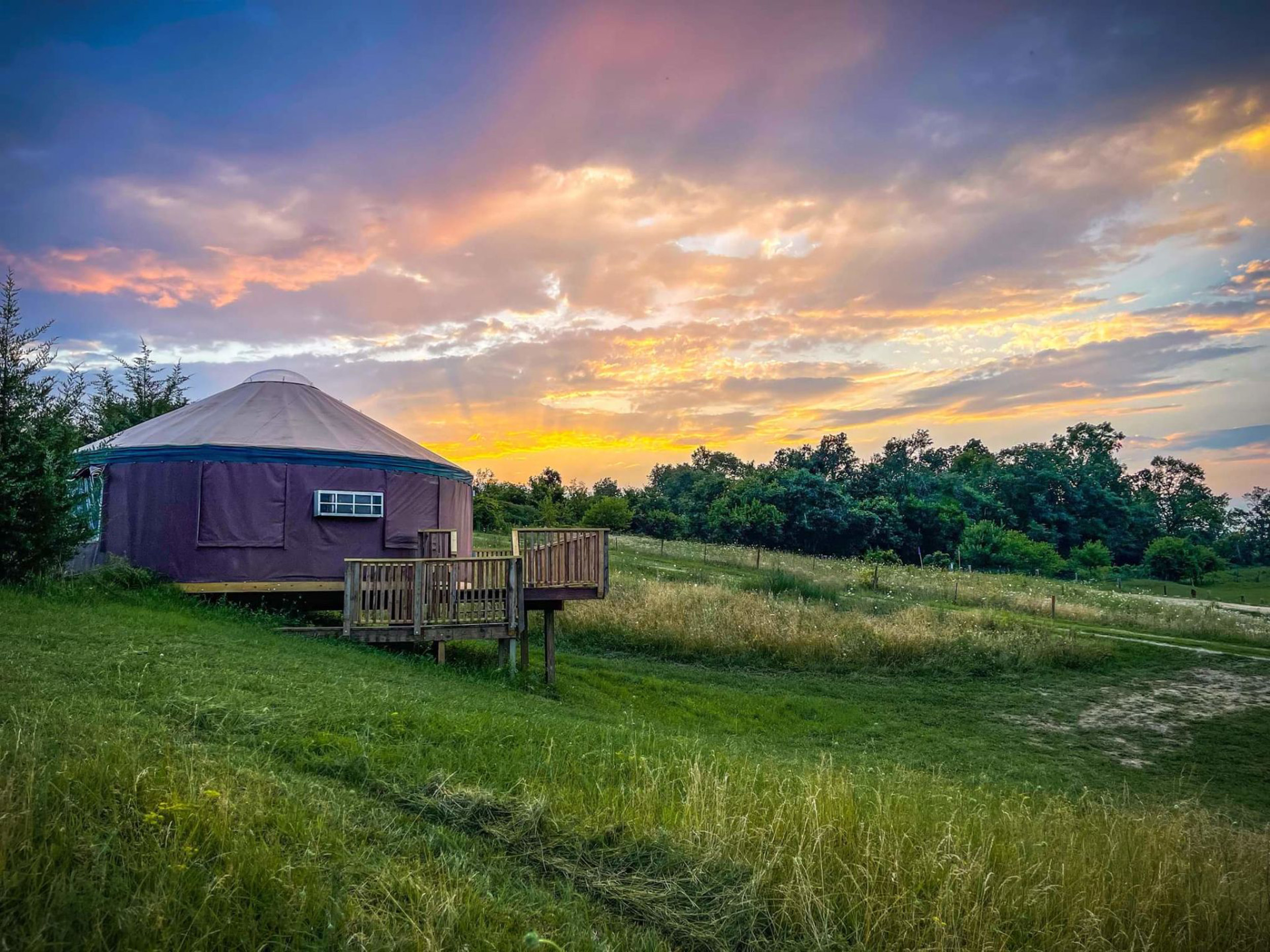 A sunet over Windy Goat Acres, a Hipcamp in Iowa.
