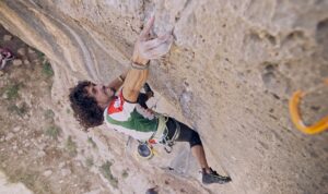 a climber pulling hard on a hold