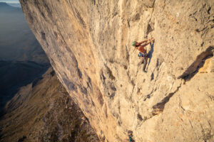 bronwyn hodgins climbing the blonde limestone of el gavilan in full sun