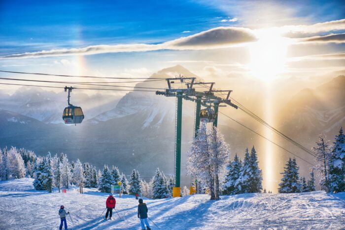 skiers and a lift at lake louise ski resort, banff, canada