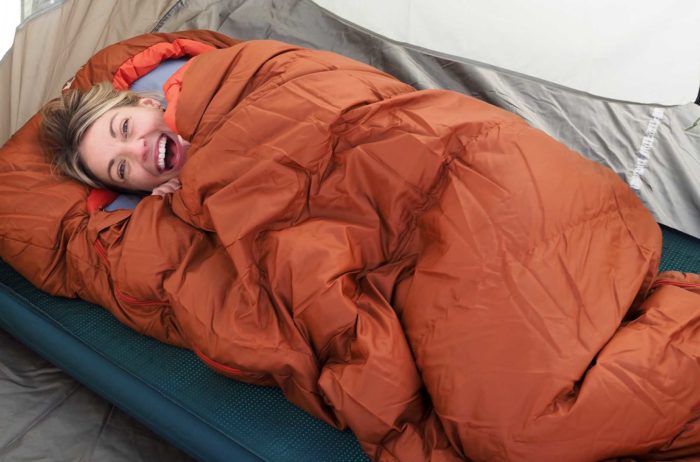 happy woman in a sleeping bag