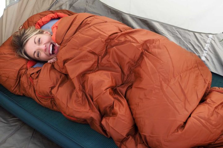 happy woman in a sleeping bag