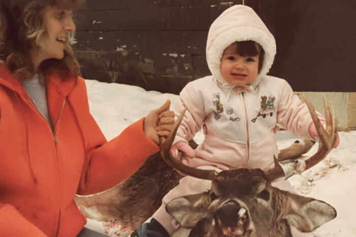 Rachelle Schrute as a child with her mother's successfully hunted buck