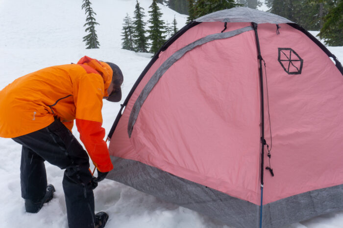 A Climber Setting Up the Samaya 2.5 Tent