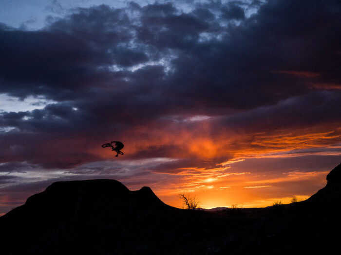 Mountain biker getting air at sunset