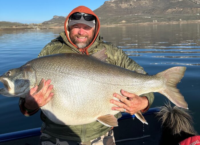 scott enloe holding the huge lake trout
