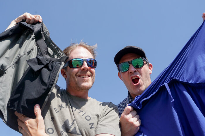 two men holding up running shorts