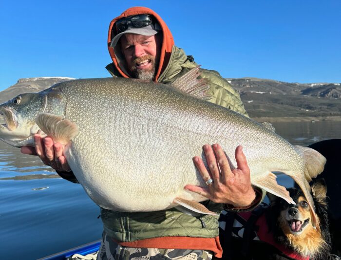 scott enloe holding a massive lake trout