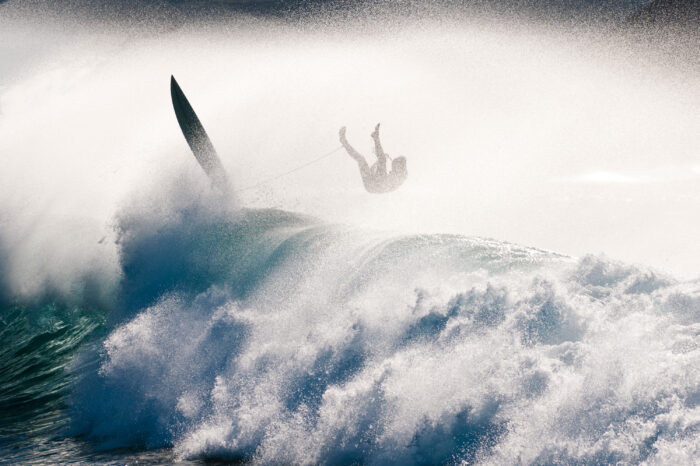 surfer wiping out on huge wave