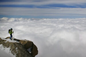 a man stands on top of a mountain