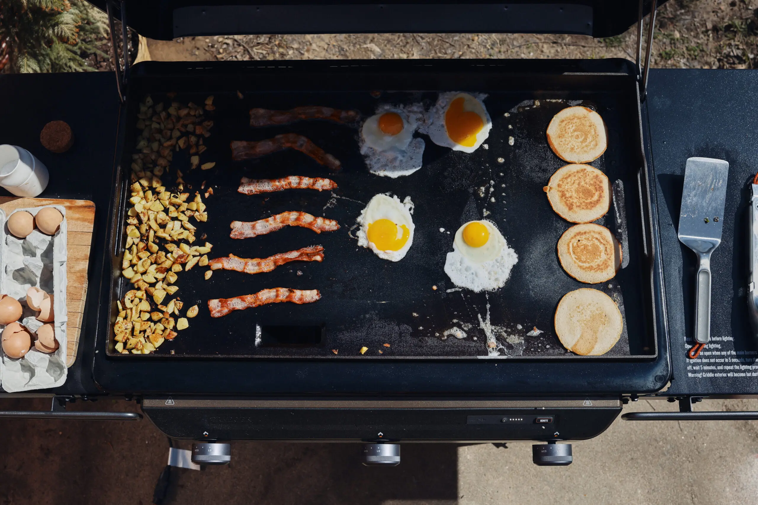 traeger flatrock propane grill cooking eggs, pancakes, and bacon