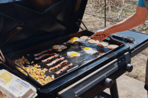 traeger flatrock propane grill cooking eggs, bacon, and pancakes