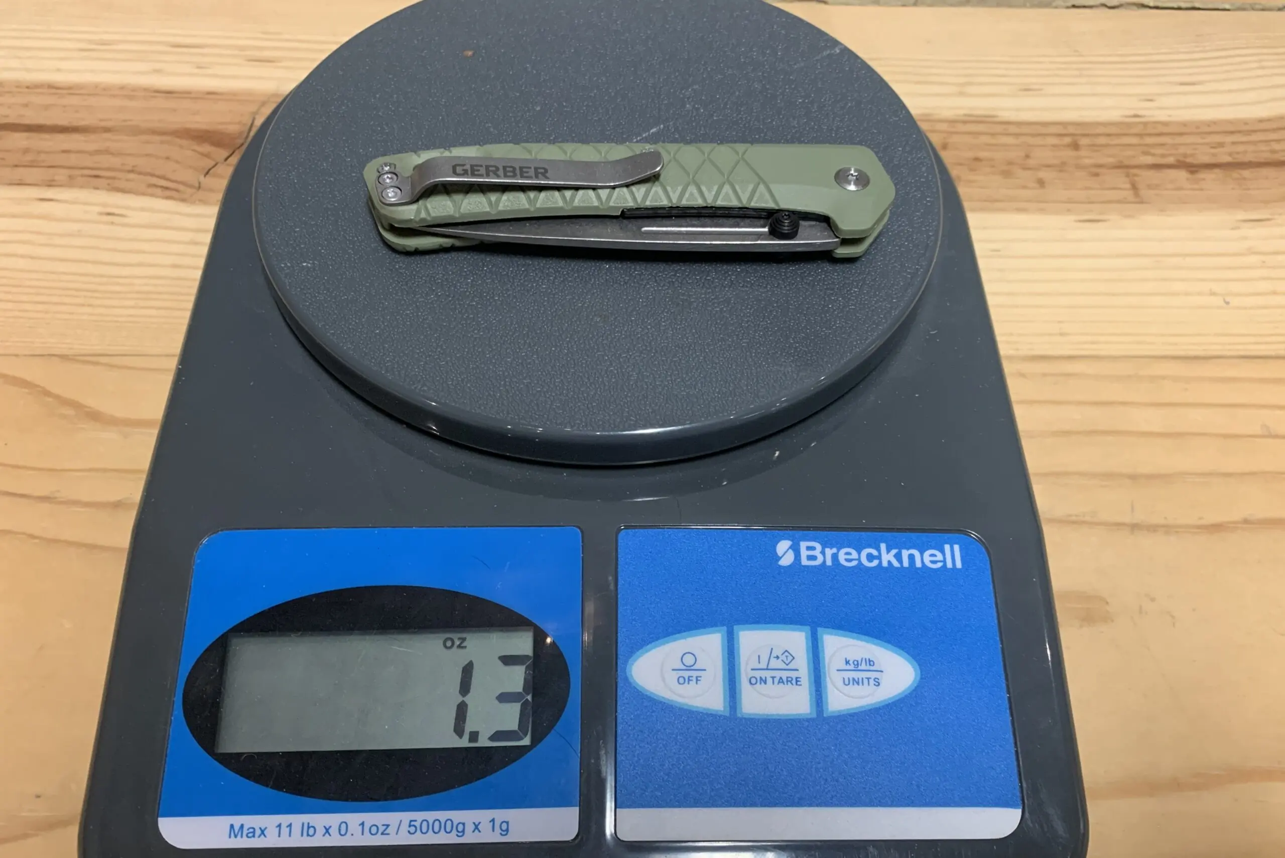 the gerber zilch knife being weighed on a postal scale
