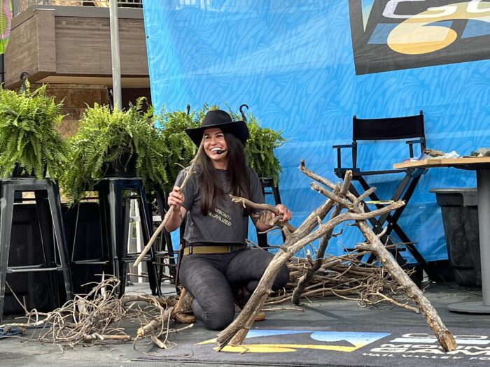 Laura Zerra demonstrates how to build a survival shelter at the GoPro Games; (photo/Meredith Guinan)