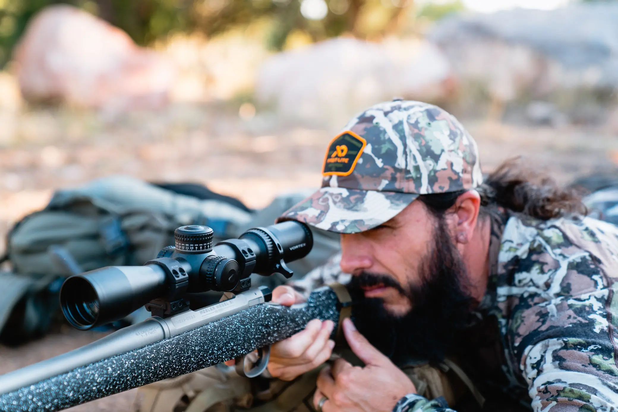 Author aiming through strike eagle riflescope