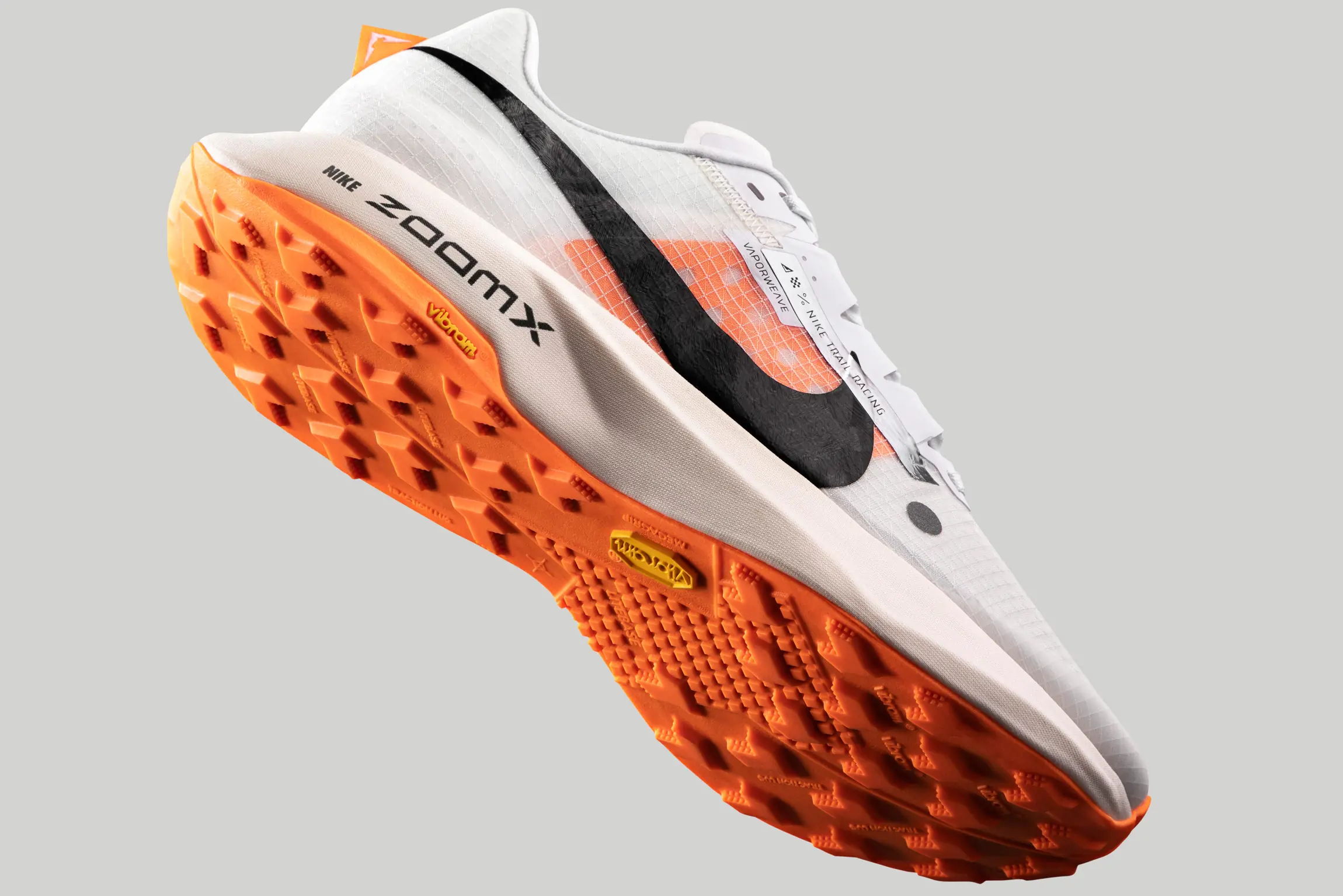 Nike Ultrafly Trail running shoe floating on grey background