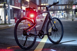 an Urtopia bike on a street at night