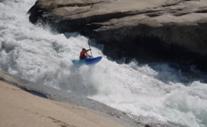 a kayaker getting some air while paddling the upper cherry river in california
