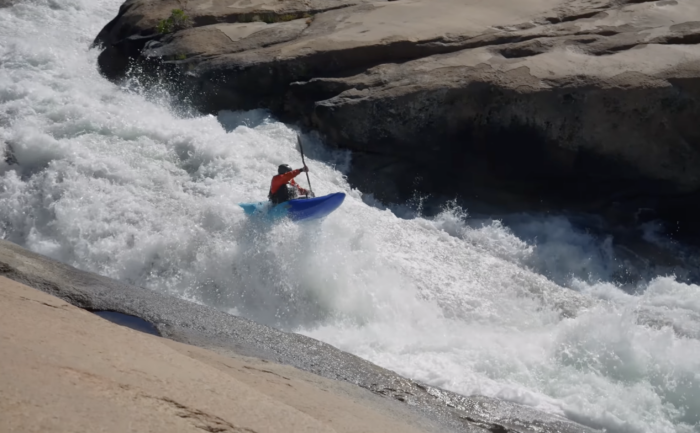 a kayaker getting some air while paddling the upper cherry river in california