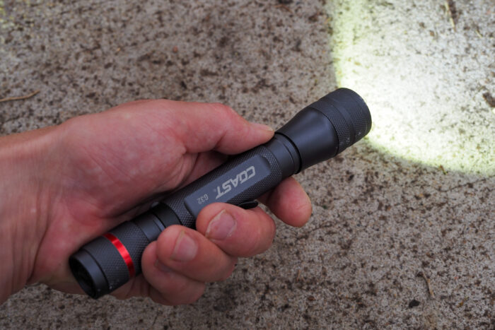 Coast G32 flashlight in hand