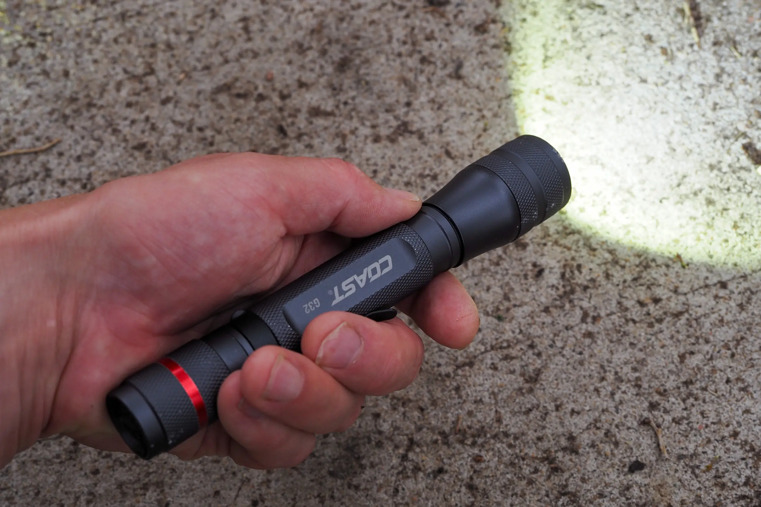 Coast G32 flashlight in hand