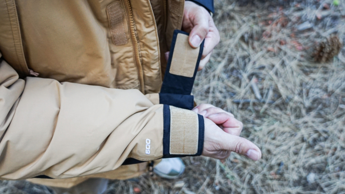 A man demonstrates the velcro sleeve cuffs on The North Face McMurdo Down Parka.