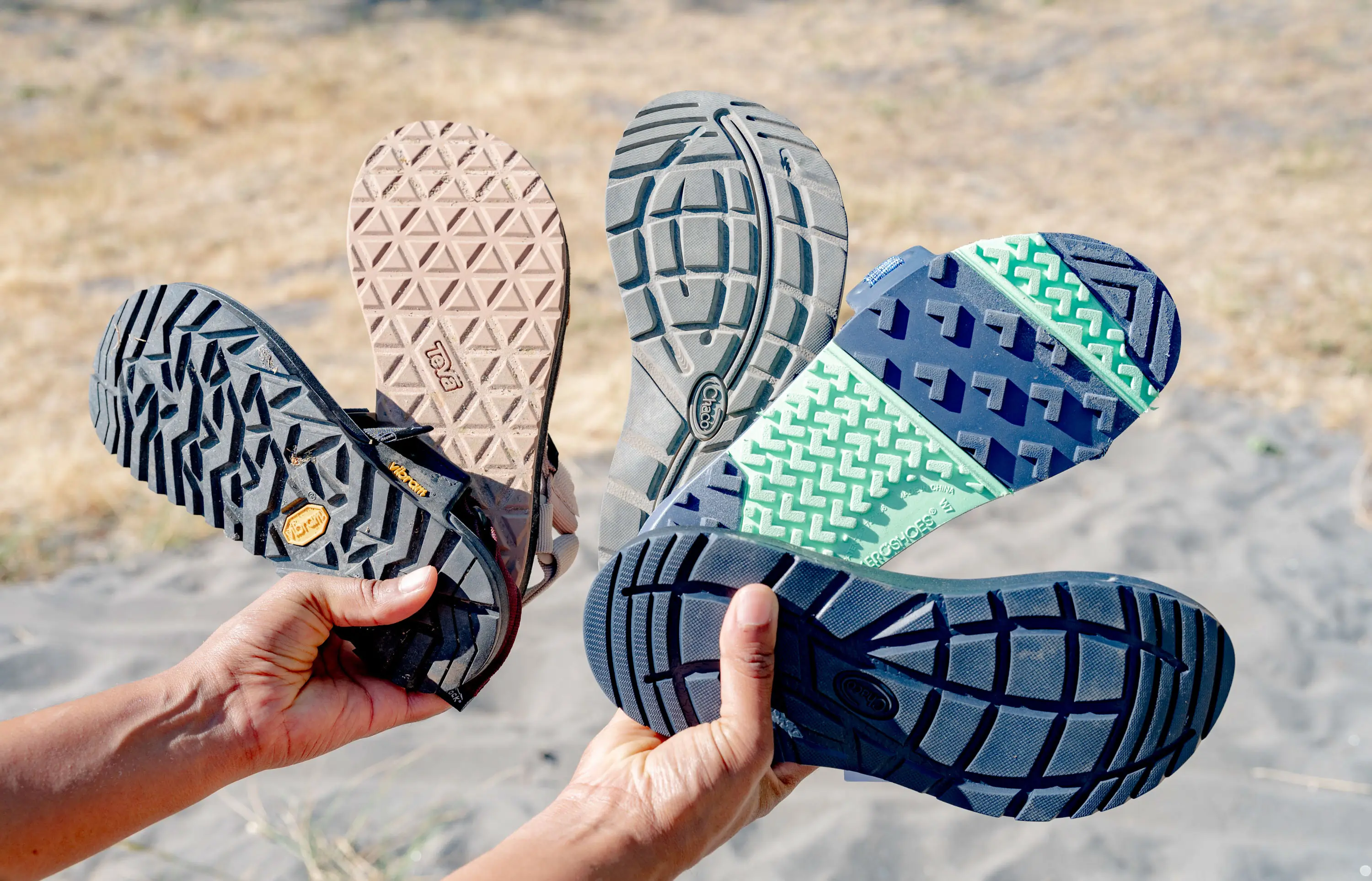 a women fans out different hiking sandals to detail the outsole designs