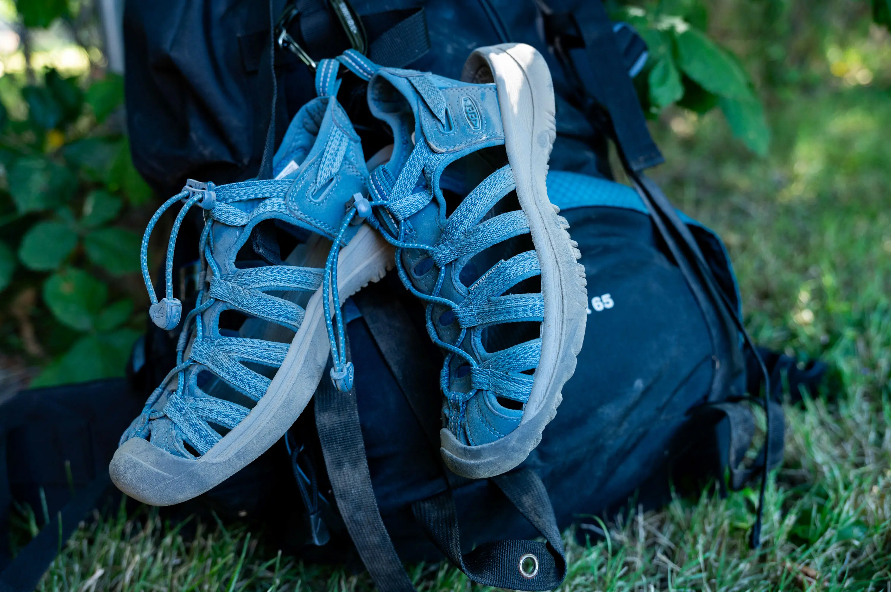 Keen Women's Whisper Sandal strapped to a backpack