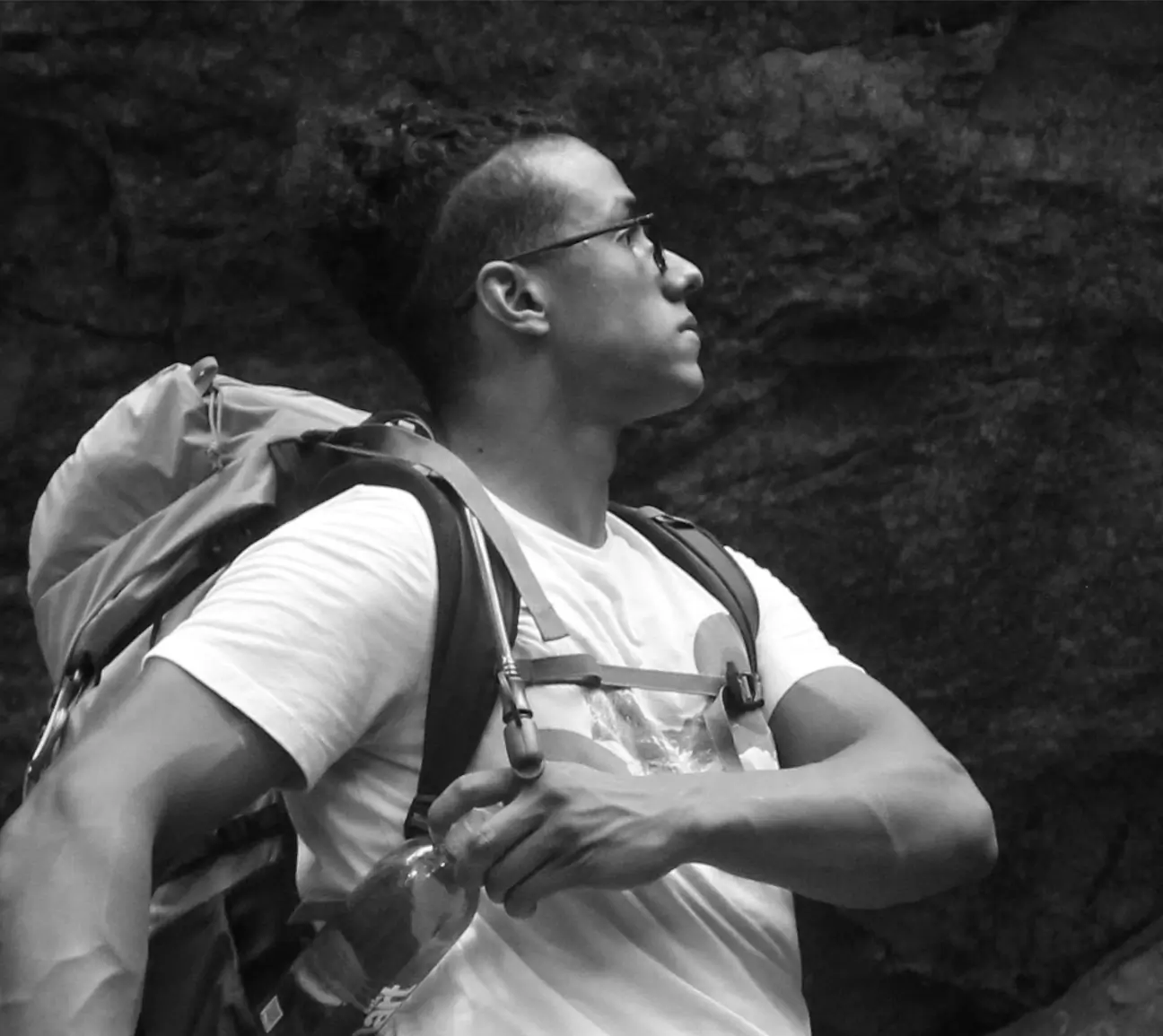 Author Ian Graber-Stiehl wearing a short sleeve tee and pack while hiking in a canyon