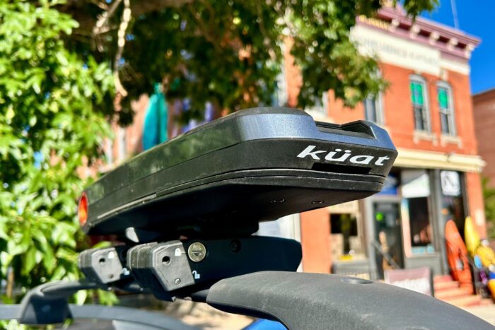 an orange and gray kuat class 4 rack on the roof of a car
