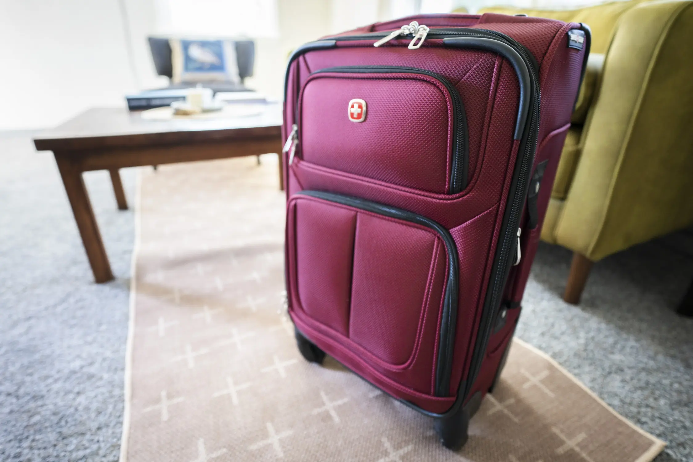 A close up shot of a red piece of carry-on luggage