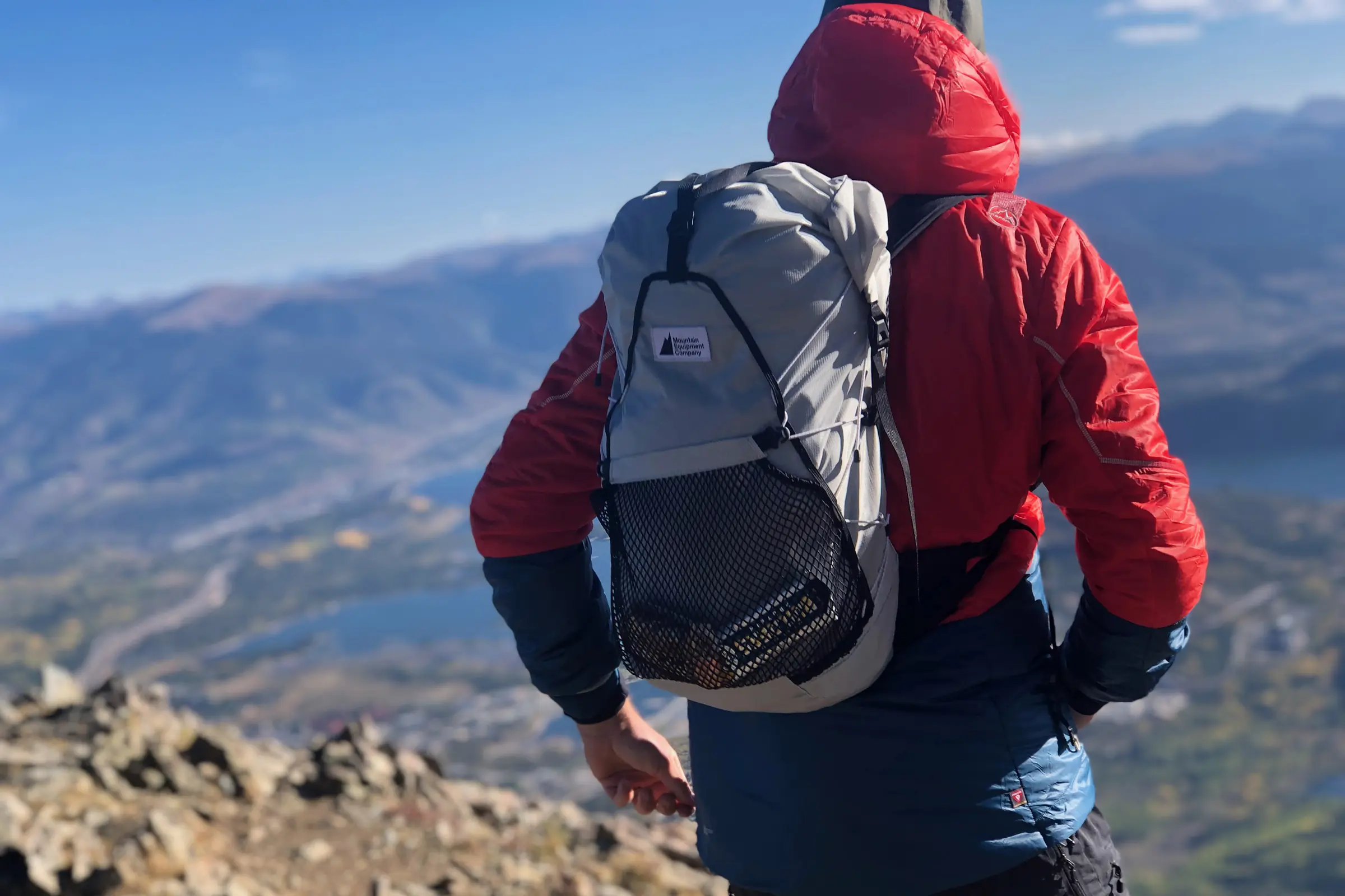 author wearing a bacpack facing a mountain
