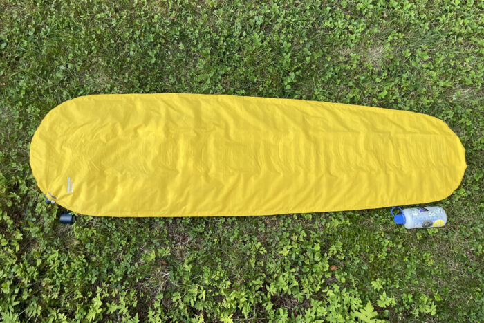 Therm-a-Rest Neo Air XLite NXT sleeping pad from above with a nalgene bottle to it's side for scale