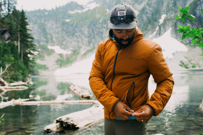 man wearing beyond clothing ultra lochi 2.0 jacket by mountains