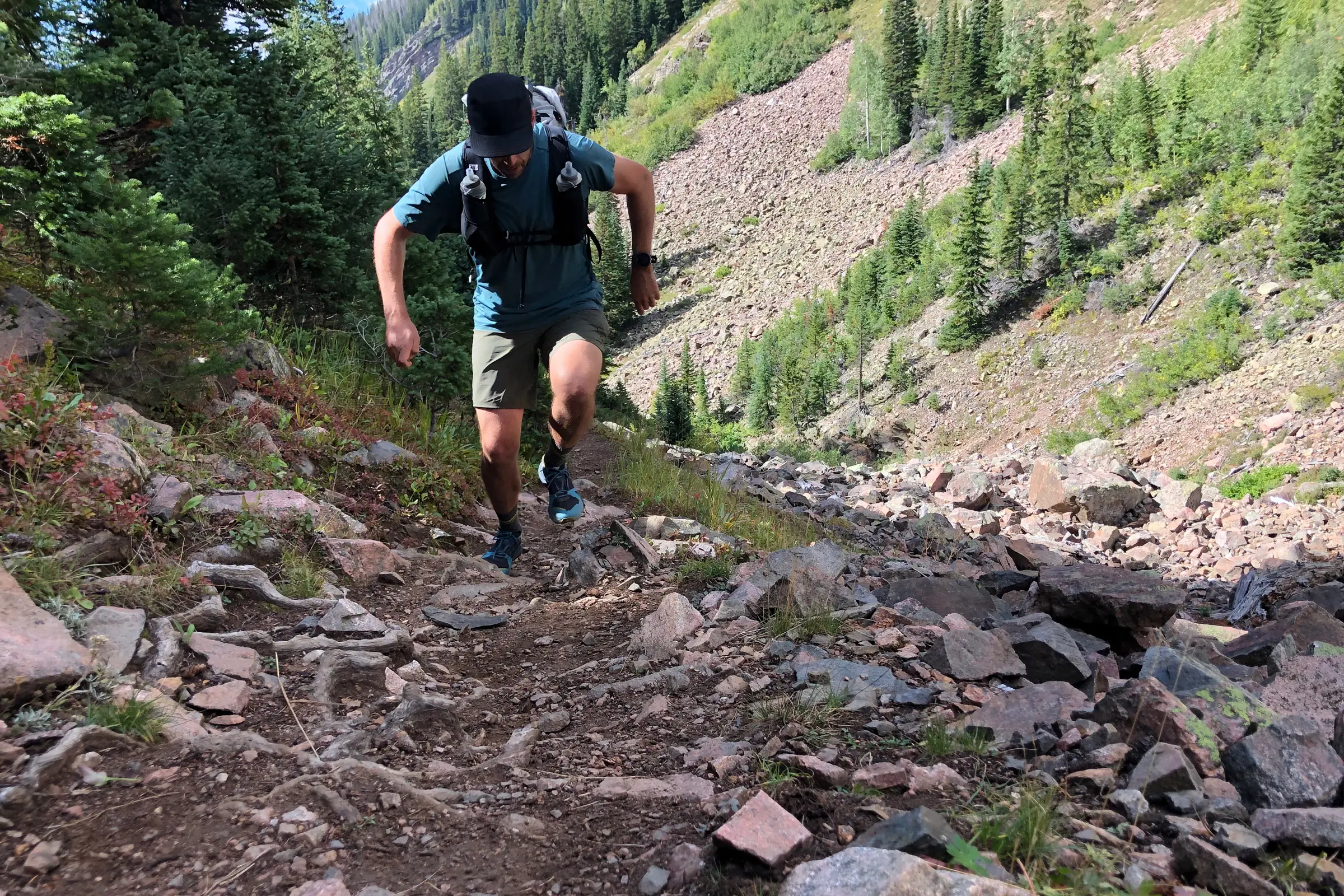 author going uphill wearing the serratus pace ul 25l pack