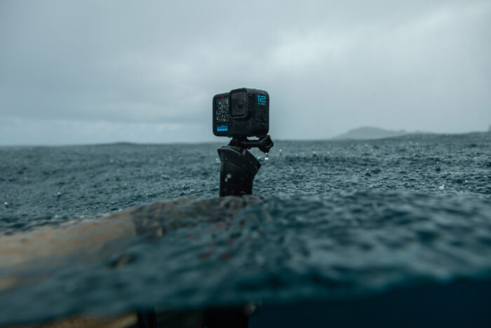 gopro hero12 black camera held in the middle of the ocean