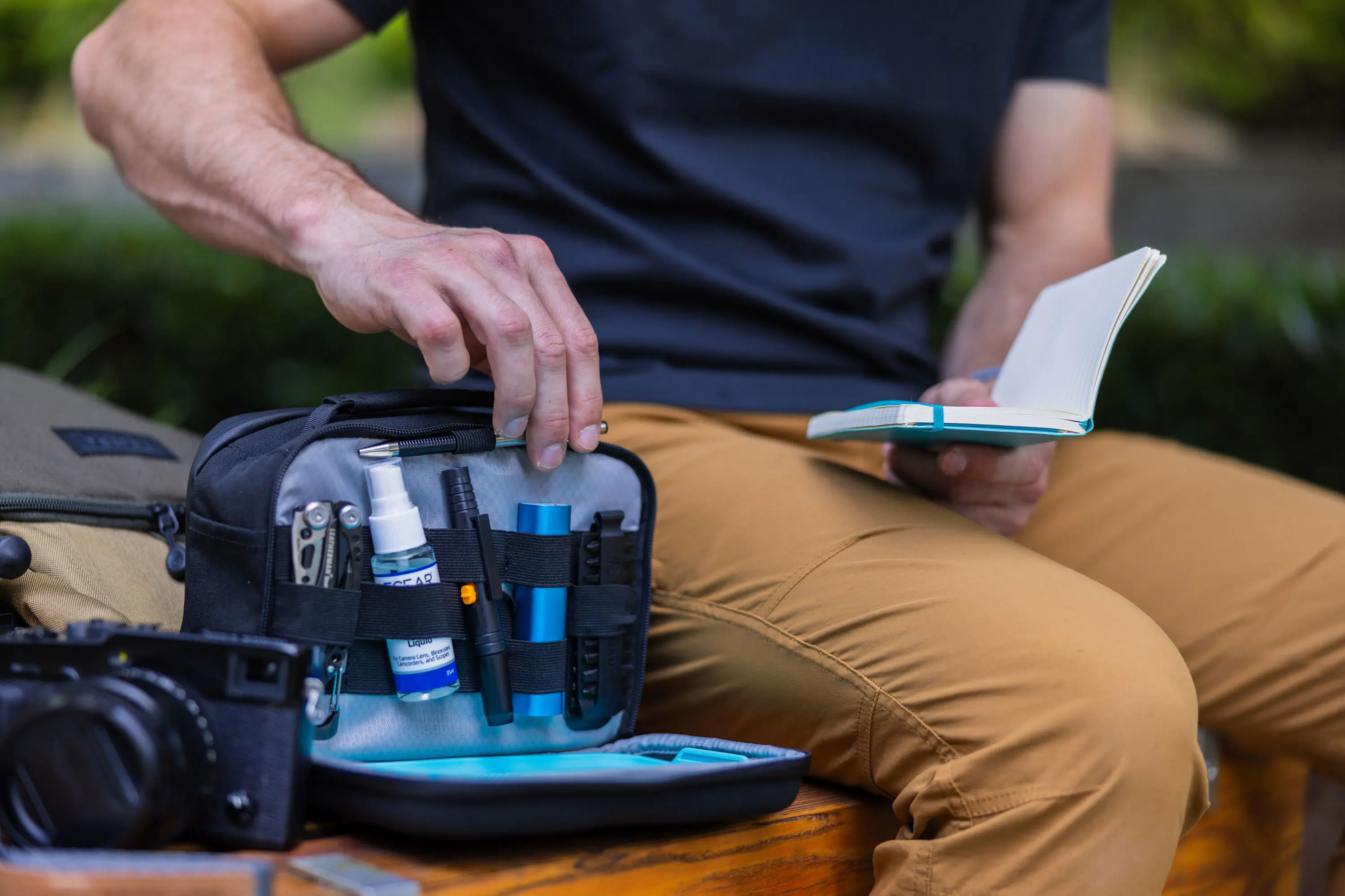 man opening a leatherman adapt photography pack