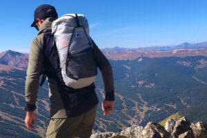 hiker on mountain with mec serratus pack