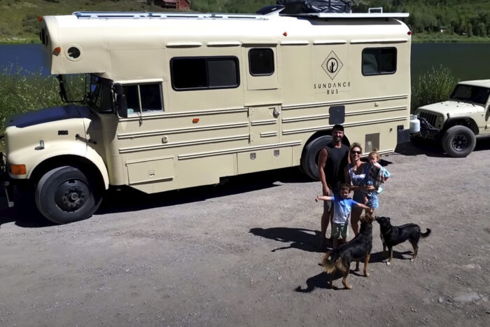 an ariel view of a converted school bus and a white jeep