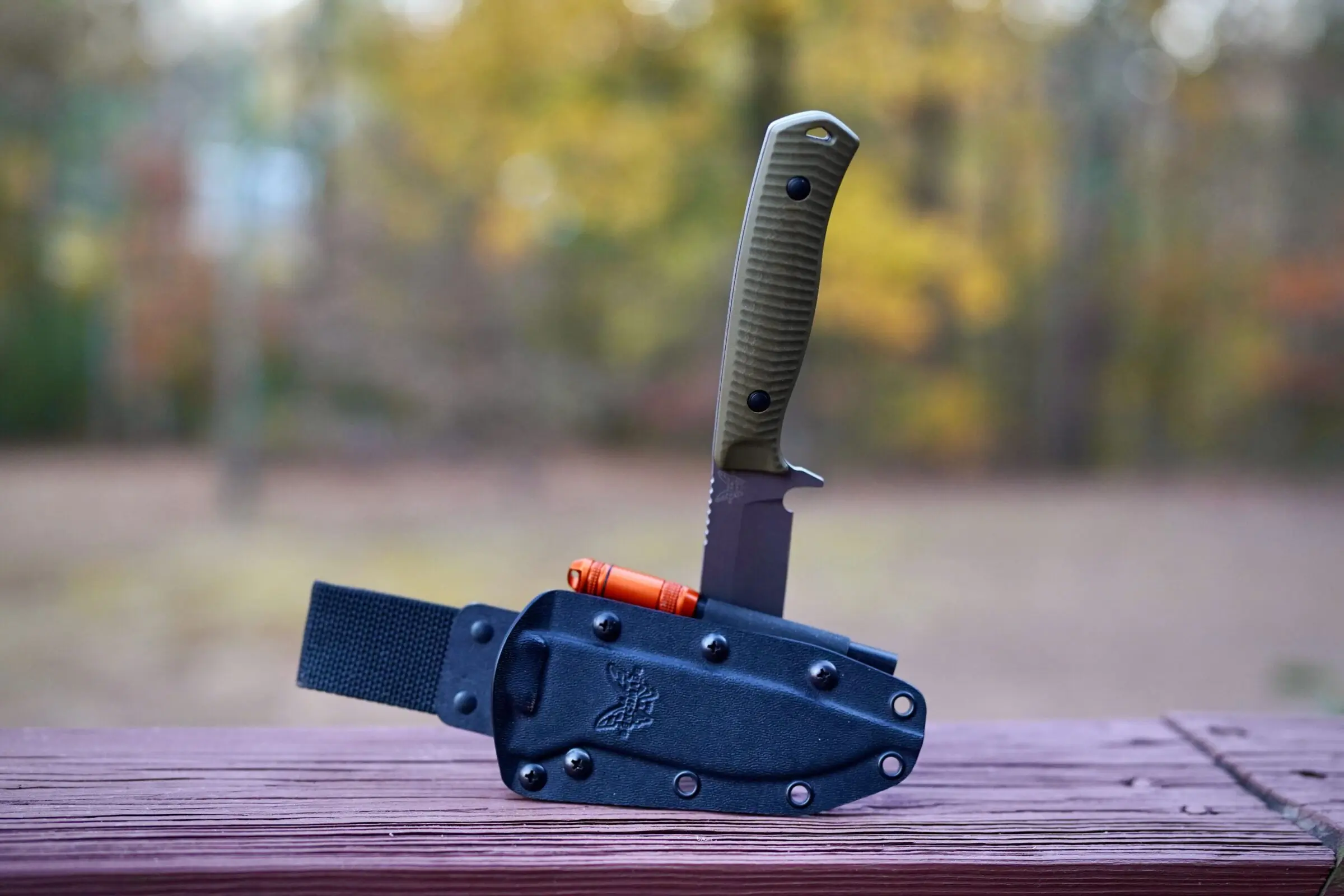 A ferro rod fire starter in the sheath of a knife