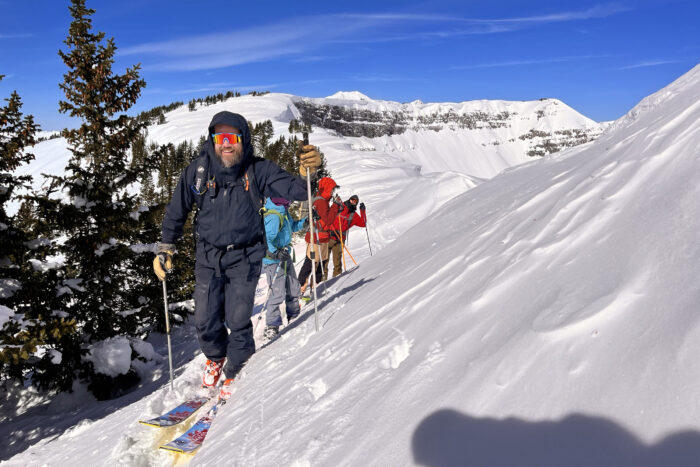 Group of skiers moving through a snowy mountain