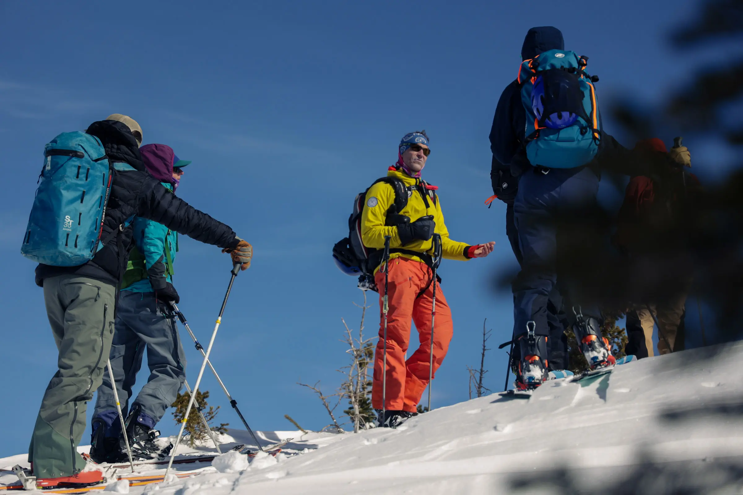 Group of snow hikers getting ready to start their trail while using the avalanche prevention app