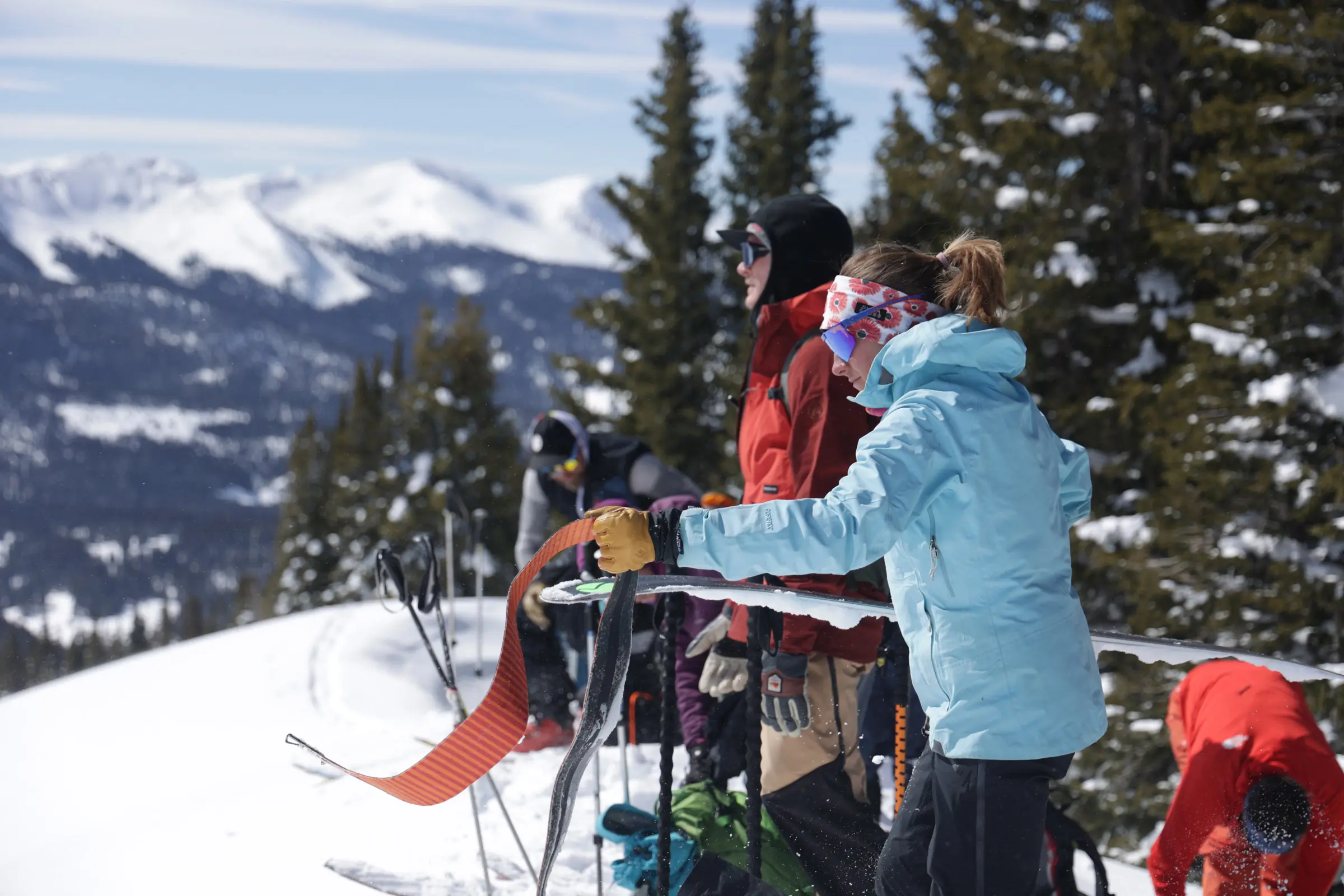 Group of skiers getting ready to go through a snowy mountain trail