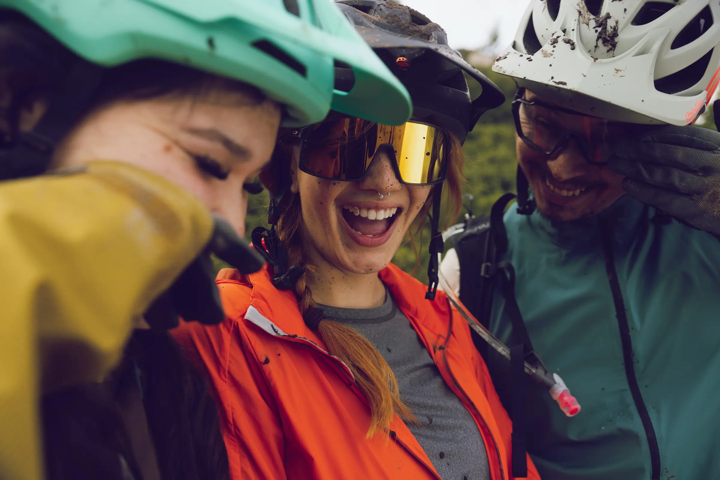 A group of cyclists get muddy. 