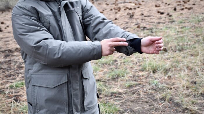 A man showing the sleeve cuffs of the Eddie Bauer Superior Down Parka.