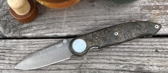crkt pursue knife displayed on a wood table