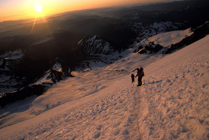 climbing team going up a snowy mountain in Mount Rainier National Park - (Photo/Bergen Tjossem)