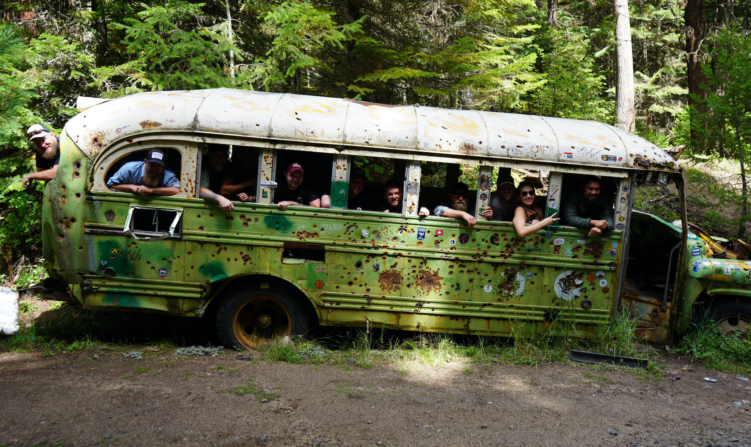The V/O crew explore an abandoned, shot-up bus along the BDR; (Photo/Veteran Overland)