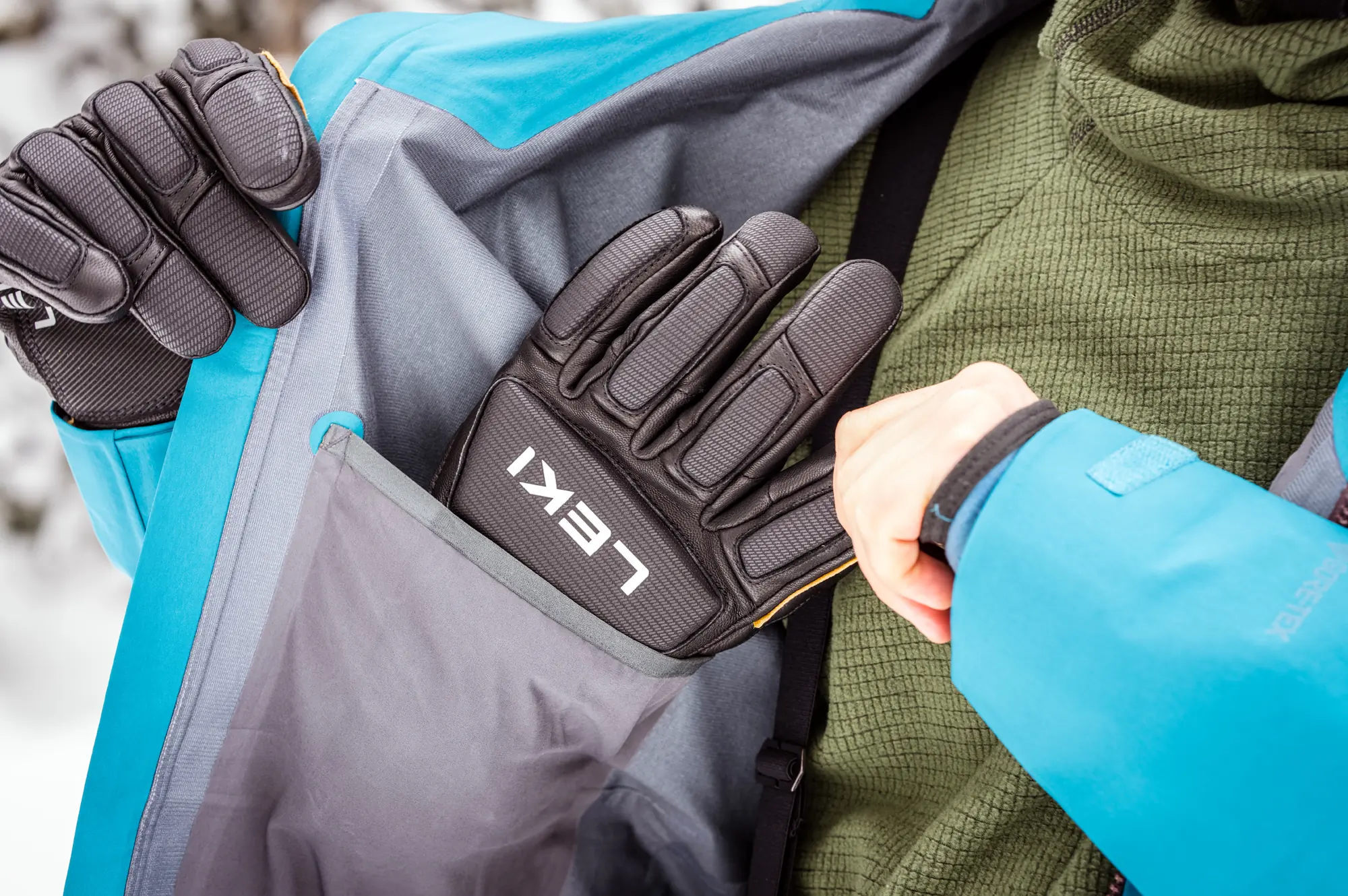 man pulling ski gloves out of dump pocket